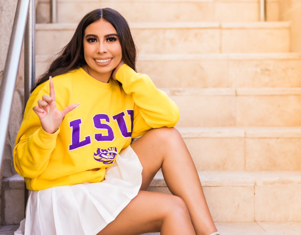 girl wearing yellow LSU sweatshirt